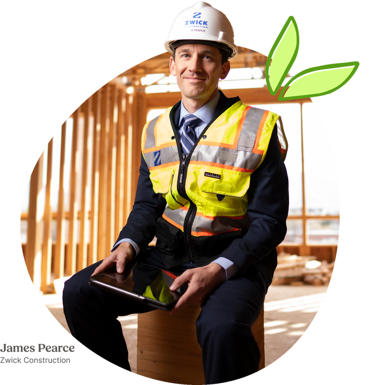 A construction professional in a suit and safety vest, seated on a wooden beam at a construction site, holding a tablet, with a green leaf graphic overlay on the upper right