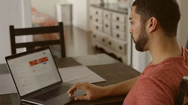 A man searches for a job on his computer